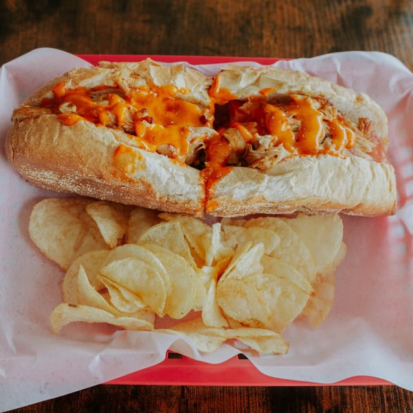 Buffalo chicken sub served with crisp potato chips.
